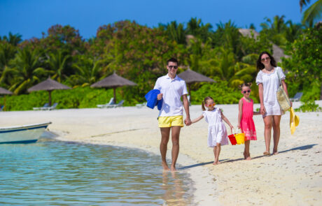 Happy family during summer vacation on white beach